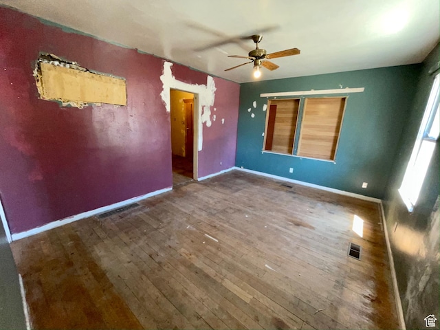 spare room with ceiling fan and dark wood-type flooring