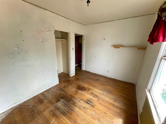 empty room with hardwood / wood-style floors