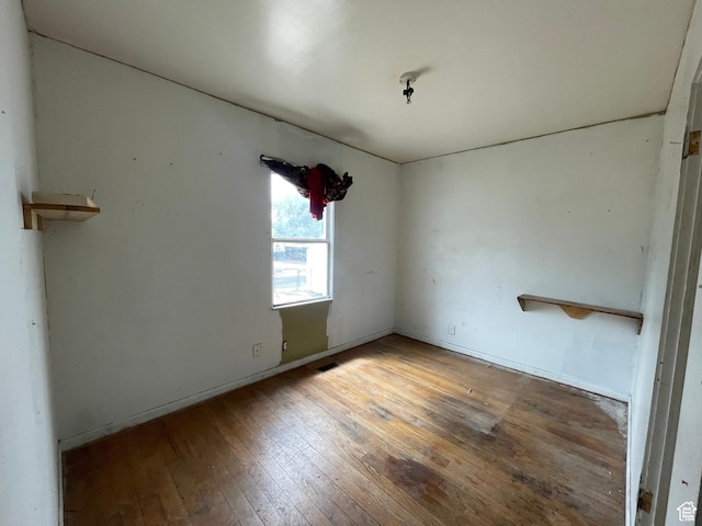 unfurnished room with wood-type flooring