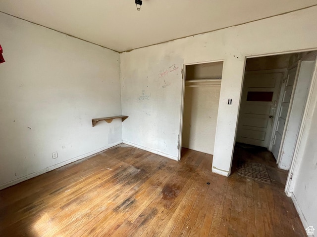 unfurnished bedroom with hardwood / wood-style flooring