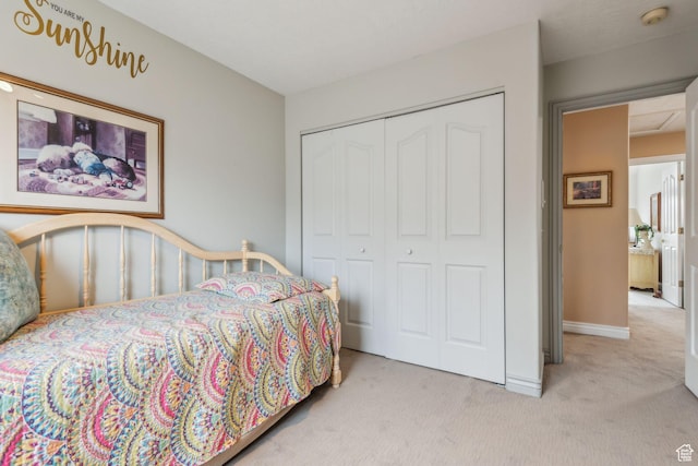 bedroom featuring a closet and light carpet