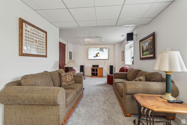 living room with light carpet and a drop ceiling