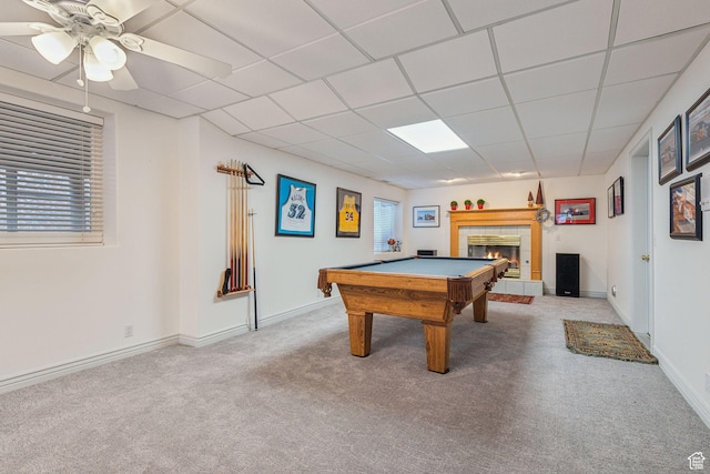 recreation room with pool table, a paneled ceiling, a tile fireplace, carpet flooring, and ceiling fan