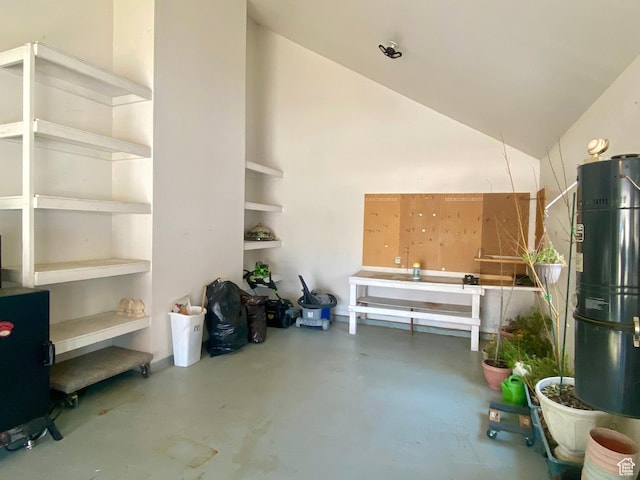 garage with gas water heater and a workshop area