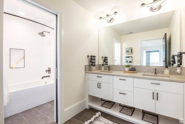 bathroom featuring tasteful backsplash, vanity, and bathtub / shower combination