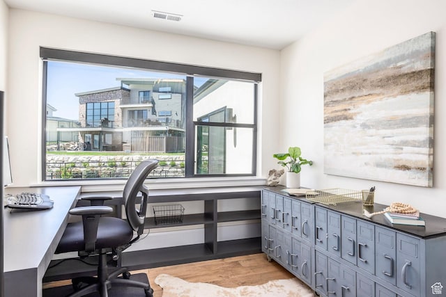 office space featuring plenty of natural light and light wood-type flooring