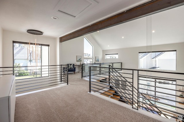 corridor featuring carpet floors and vaulted ceiling