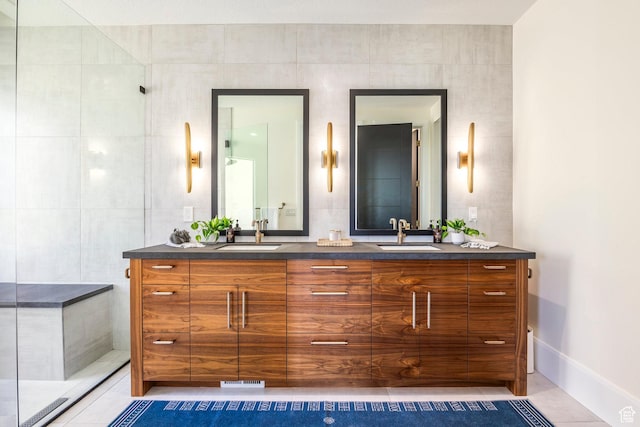bathroom featuring vanity, tile patterned floors, and tile walls