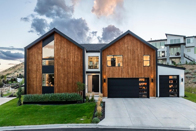 modern home with a yard and a garage