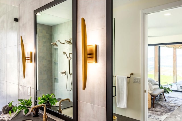 bathroom featuring a tile shower and sink