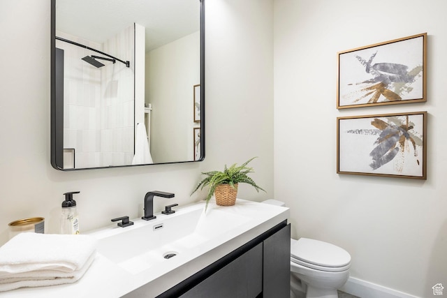 bathroom featuring vanity, toilet, and walk in shower