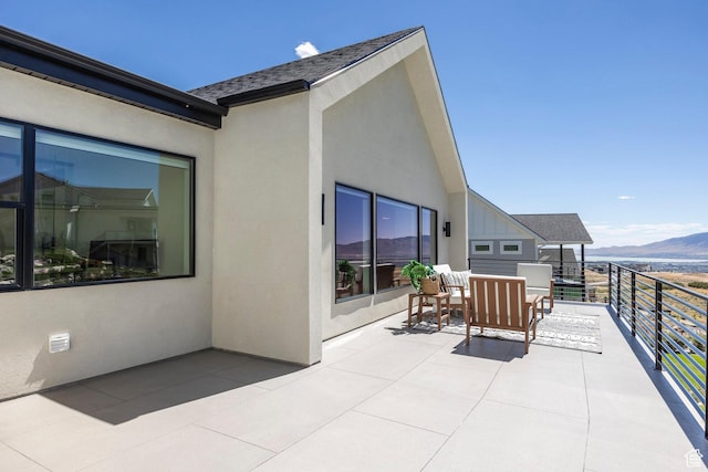 view of patio featuring a mountain view and a balcony