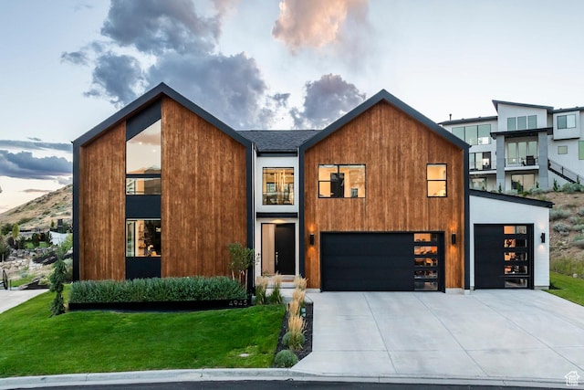 modern home featuring a garage and a lawn