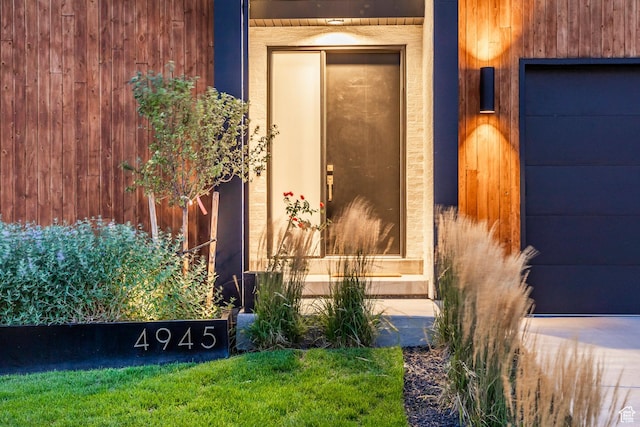 view of exterior entry with a garage