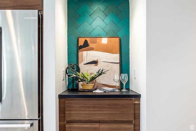 interior details featuring bar area and stainless steel fridge