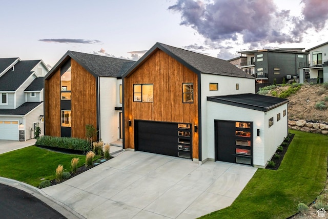 modern home with a yard and a garage