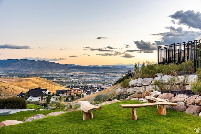 view of home's community with a mountain view and a yard