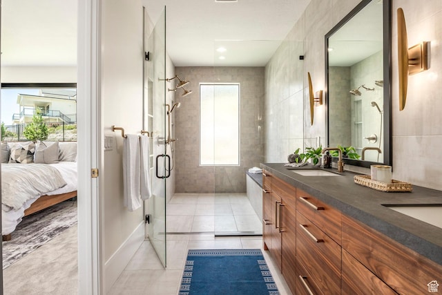 bathroom featuring tile patterned floors, a shower with door, and vanity