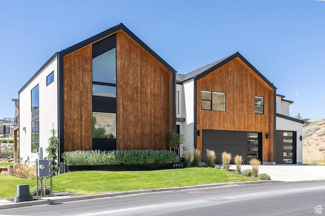 contemporary house with a front lawn and a garage