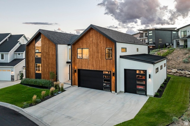 modern home featuring a garage and a front lawn