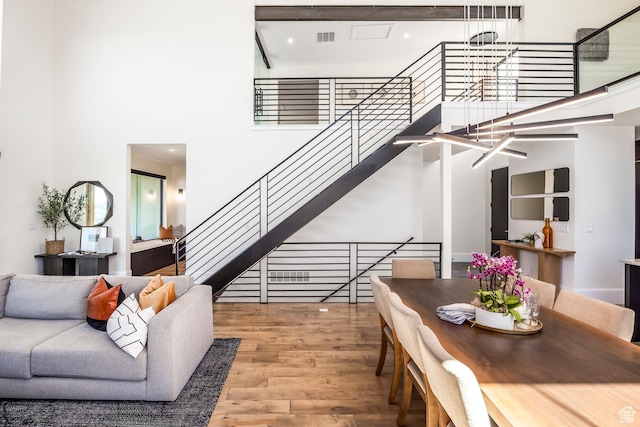 living room featuring hardwood / wood-style floors and a high ceiling