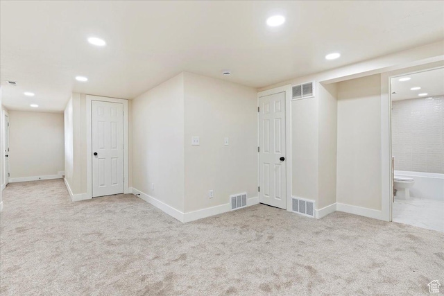 basement featuring light carpet