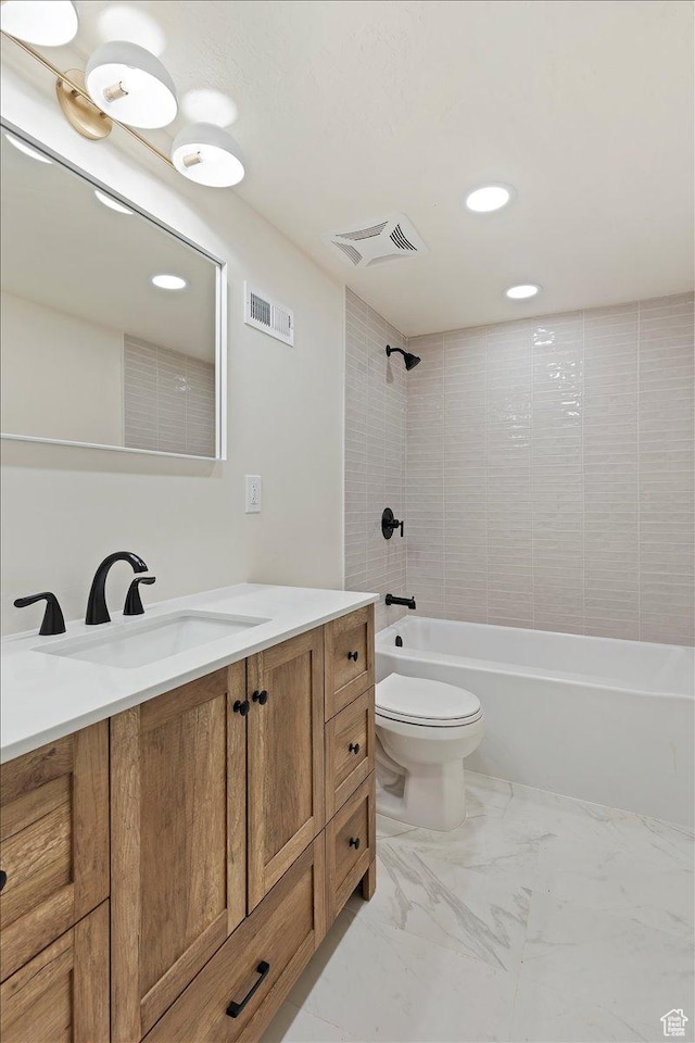 full bathroom with vanity, toilet, and tiled shower / bath combo