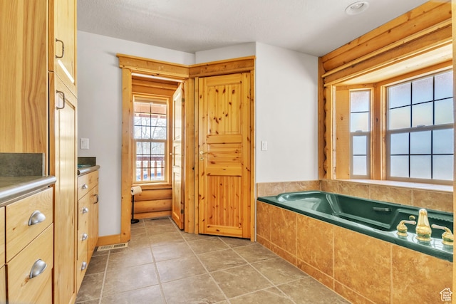bathroom featuring a washtub and a textured ceiling