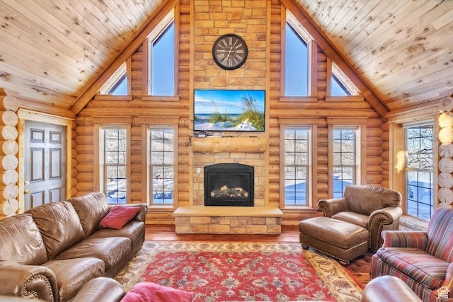 living room with wood-type flooring, high vaulted ceiling, a stone fireplace, and rustic walls