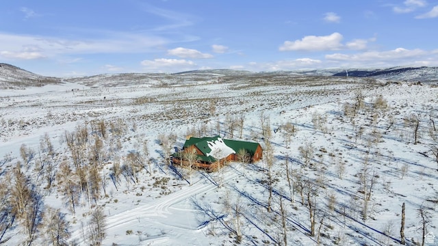 snowy aerial view with a mountain view