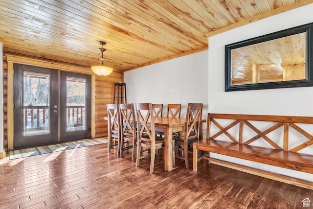 unfurnished dining area featuring hardwood / wood-style floors, wooden ceiling, rustic walls, and french doors