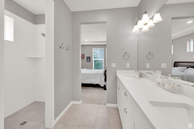 bathroom with ensuite bath, baseboards, tile patterned flooring, double vanity, and recessed lighting