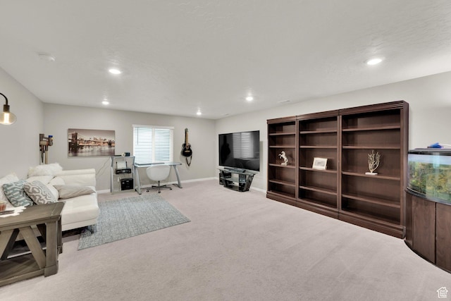carpeted living area with recessed lighting and baseboards