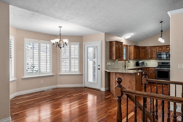 4876 S 1525 E, Ogden, UT 84403 - kitchen featuring a notable chandelier, stainless steel appliances, light countertops, and dark wood-style flooring