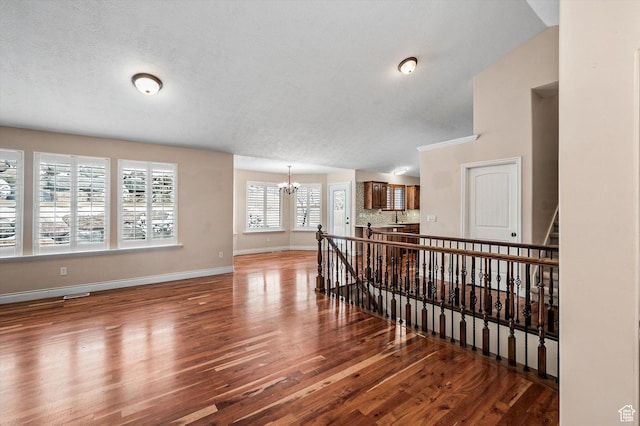 4876 S 1525 E, Ogden, UT 84403 - interior space with visible vents, baseboards, an inviting chandelier, wood finished floors, and a textured ceiling