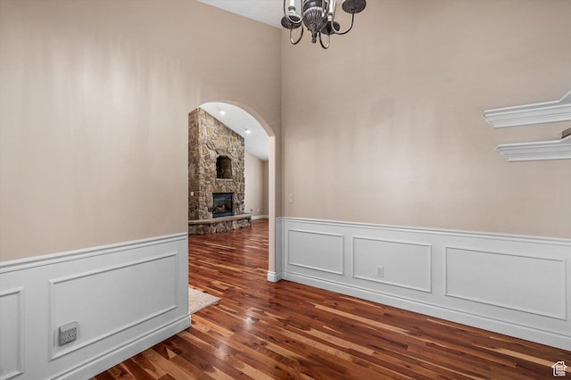 4876 S 1525 E, Ogden, UT 84403 - unfurnished dining area with a wainscoted wall, a fireplace, an inviting chandelier, and wood finished floors