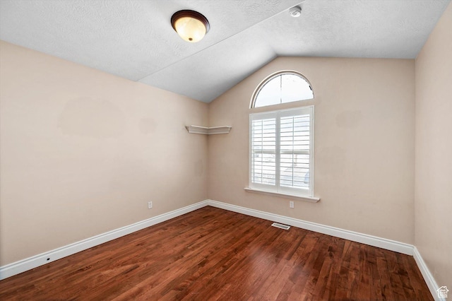 4876 S 1525 E, Ogden, UT 84403 - unfurnished room featuring visible vents, baseboards, lofted ceiling, and wood finished floors