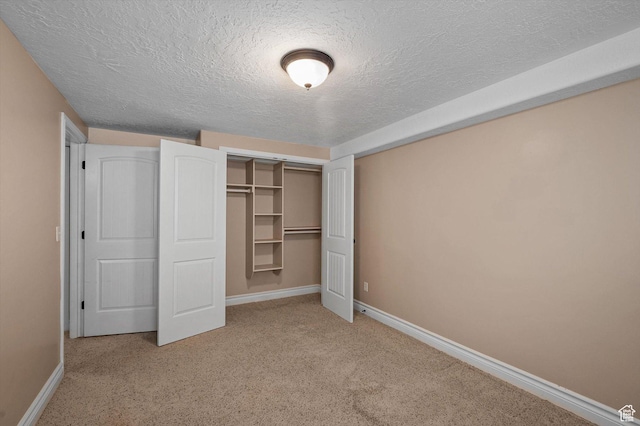 4876 S 1525 E, Ogden, UT 84403 - unfurnished bedroom featuring a textured ceiling, carpet, a closet, and baseboards