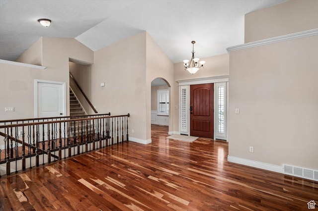 4876 S 1525 E, Ogden, UT 84403 - entrance foyer featuring visible vents, baseboards, vaulted ceiling, wood finished floors, and arched walkways
