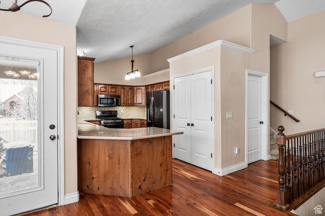 4876 S 1525 E, Ogden, UT 84403 - kitchen featuring dark wood finished floors, lofted ceiling, brown cabinets, a peninsula, and stainless steel appliances