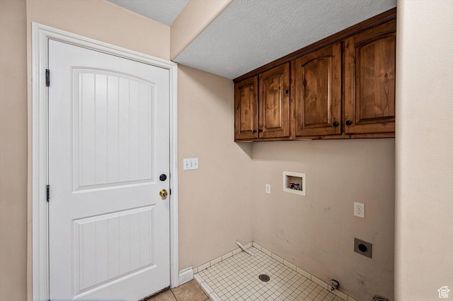 4876 S 1525 E, Ogden, UT 84403 - laundry area with electric dryer hookup, a textured ceiling, cabinet space, light tile patterned flooring, and hookup for a washing machine