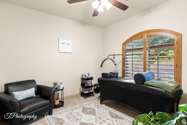 office area featuring light carpet and ceiling fan
