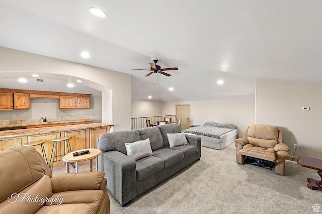carpeted living room with sink and ceiling fan