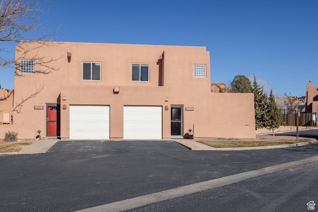 3253 E Fairway Loop, Moab, UT 84532 - pueblo revival-style home featuring a garage