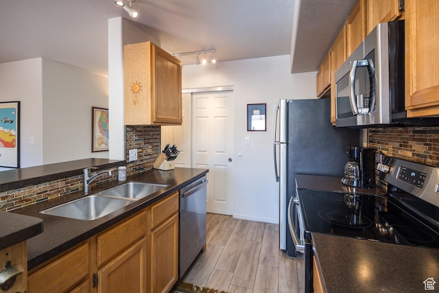 3253 E Fairway Loop, Moab, UT 84532 - kitchen featuring sink, backsplash, kitchen peninsula, and appliances with stainless steel finishes