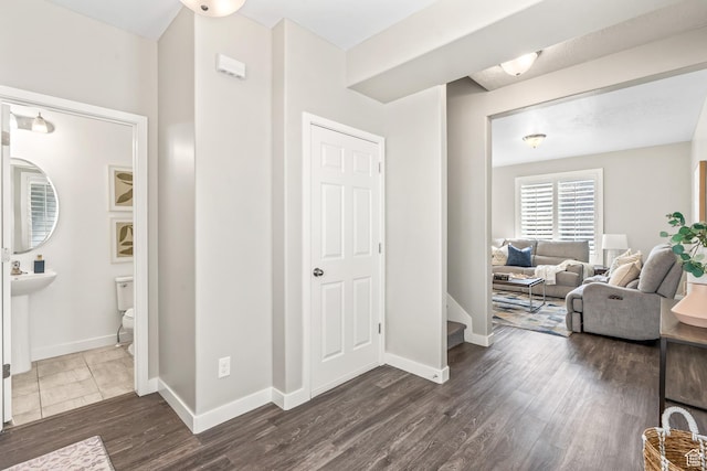 interior space featuring dark wood-style floors and baseboards
