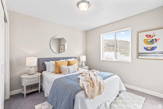 bedroom featuring baseboards and carpet