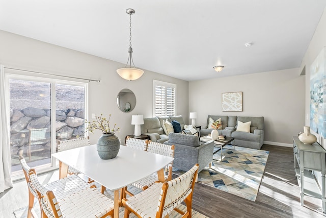 dining area featuring baseboards and wood finished floors