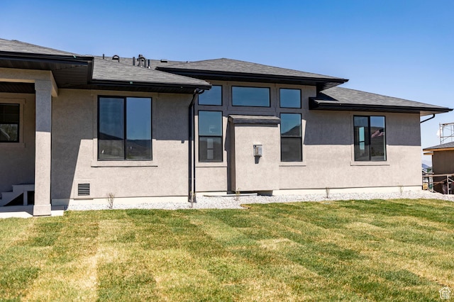 7277 W Hall Crossing Dr S, Herriman, UT 84096 - rear view of house with a yard, a shingled roof, and stucco siding