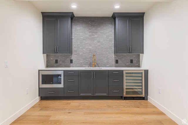 7277 W Hall Crossing Dr S, Herriman, UT 84096 - bar featuring indoor wet bar, stainless steel microwave, a sink, wine cooler, and decorative backsplash